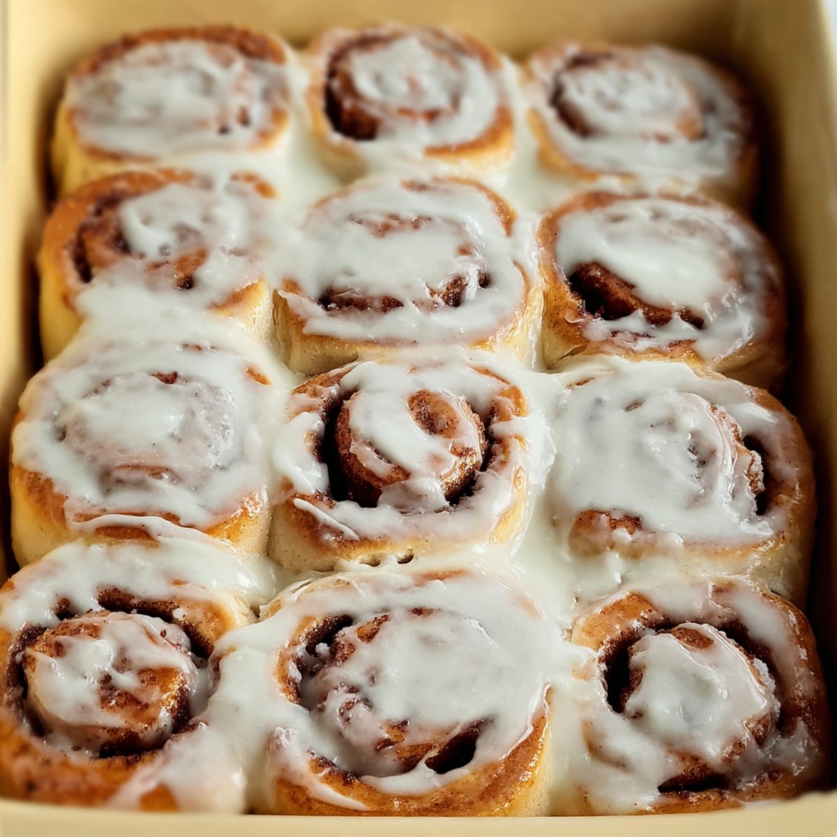 Soft and fluffy cinnamon rolls topped with a smooth layer of cream cheese icing, perfect for breakfast or dessert